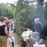 Dan, thumb bandaged, slices buns (carefully)