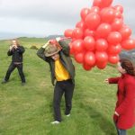 Claire goes to help Paul with the balloons