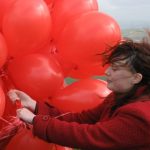 Claire is almost carried away by the balloons