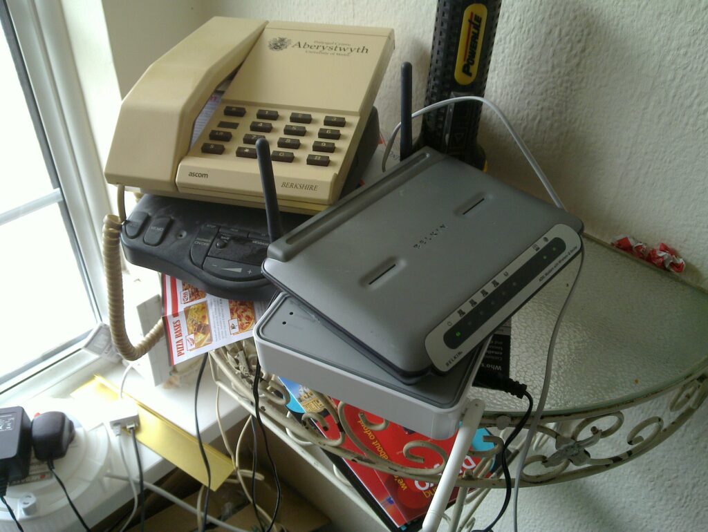 Magic Internet-box one, bottom right, hates me. Magic Internet-box two, on top of it, hates JTA. And yes, that phone does look familiar, doesn't it.