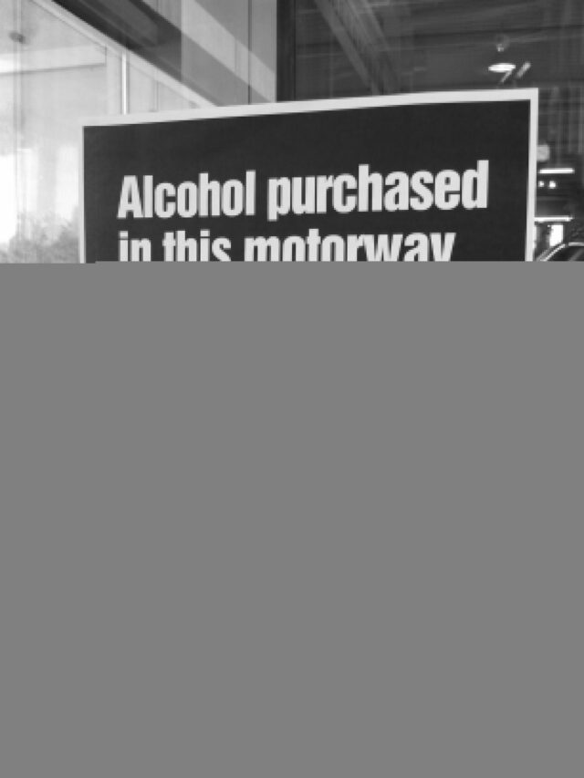 Sign: "Alcohol purchases in this motorway service area can not be consumed inside or outside the premises." Sign: "Alcohol purchases in this motorway service area can not be consumed inside or outside the premises."