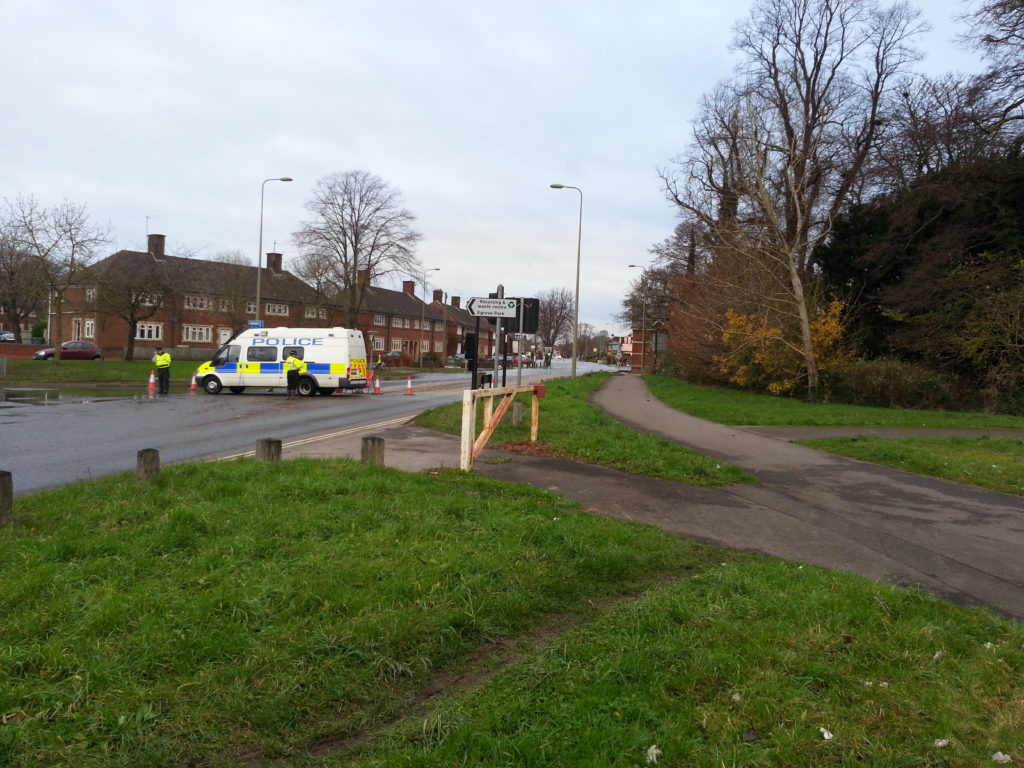 Police direct traffic away from a waterlogged Abingdon Road.