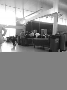 Liz gets her bags searched at airport security. Liz gets her bags searched at airport security.