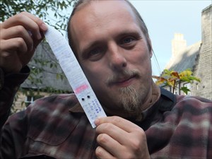 Dan with a googly-eye-emblazoned geocache log