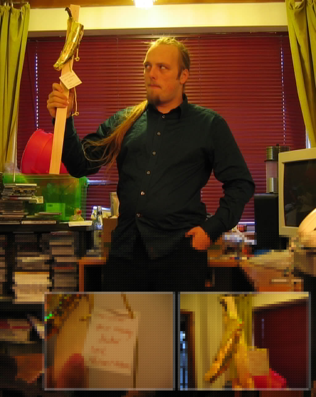 Dan with a golden banana nailed to a stick.