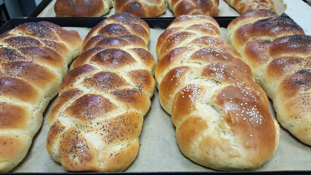 Ruth shapes her woven challah loaf.