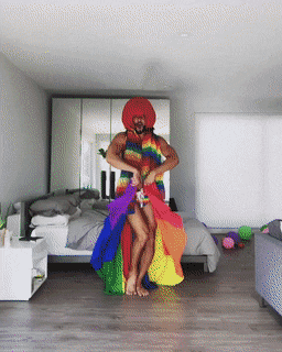 Guy dancing in many-coloured outfit