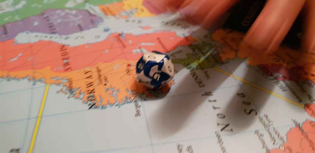 12-sided die with multiple "0" stickers placed over the sides