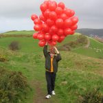 Hold on to your balloons... and hat!