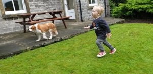 John runs through the garden.