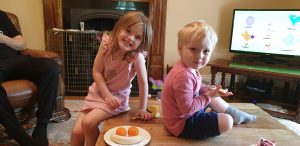Annabel and John decorate with fruit.