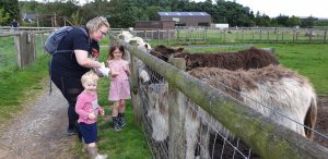Becky, Annabel and John at the petting zoo.