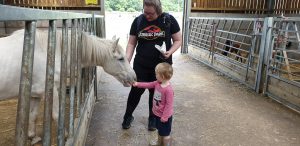 John and Becky pet a horse.