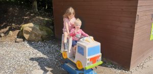 John and Annabel ride a sit-on ice cream van.