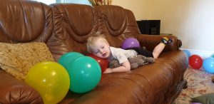 John lies on a leftover balloon on Tuesday morning.