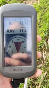 GPSr showing 0m to destination, grass visible in background