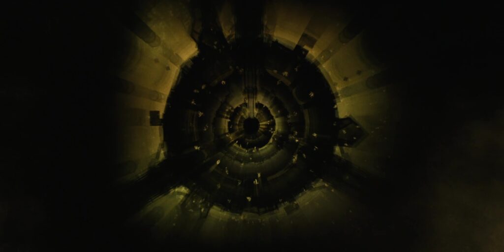 Dark circle on a yellow background with random radial spokes.