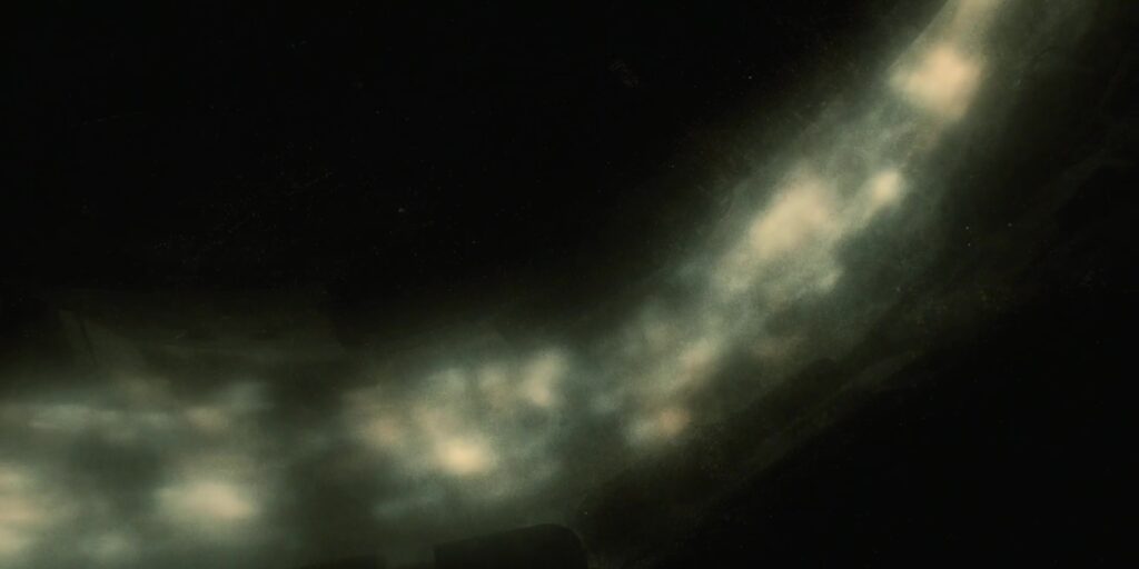 Blue-white gas wirls around a pillar.