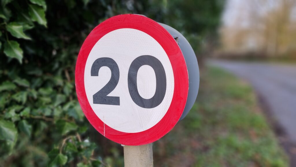 A 20mph "repeater" speed limit sign around the corner from the cache location.