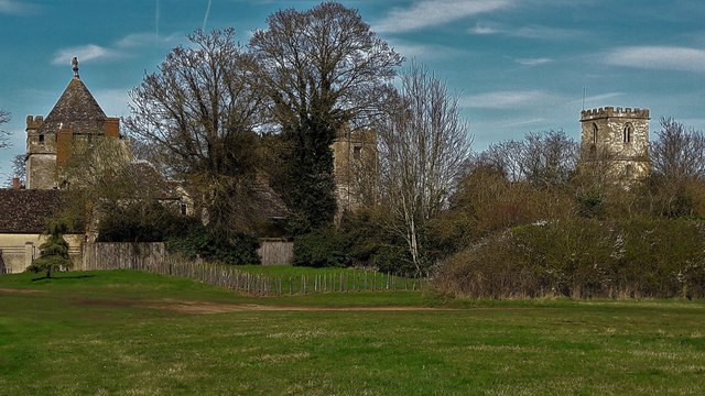 Three stone towers stand about the height of the tallest trees in Stanton Harcourt.