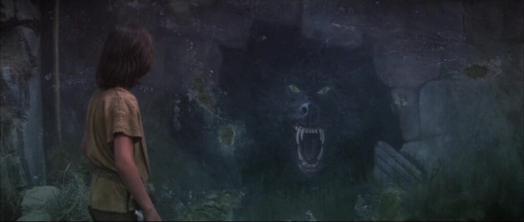 Frame from 1984's The NeverEnding Story, showing Atreyu seeing the prophetic painting that shows the beast he's about to meet.