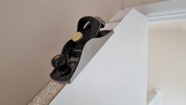 A small box plane perched atop a sloping door.