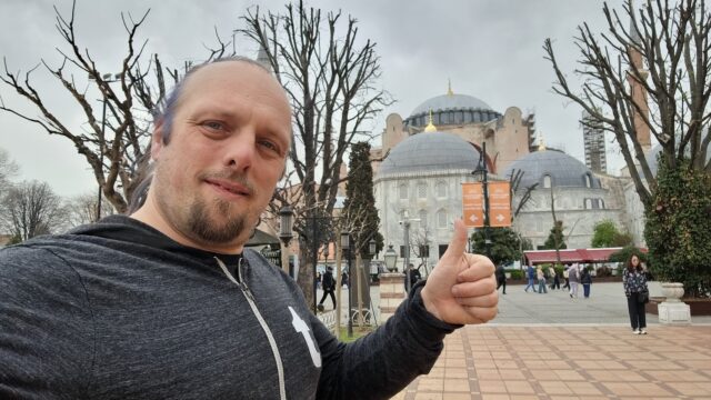 In front of the Hagia Sophia, Dan shoots a 'thumbs up' for a selfie.