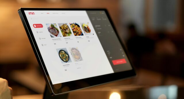 Touchscreen interactive restaurant menu with filter categories on the left and dishes for selection in the centre.