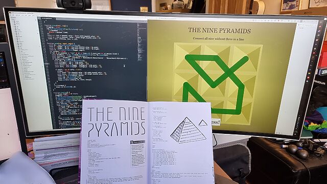 Open magazine showing program code in front of a screen showing a text editor and the running program.
