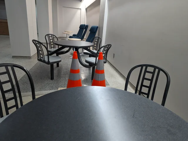 Two cones sitting at a table in a university cafe