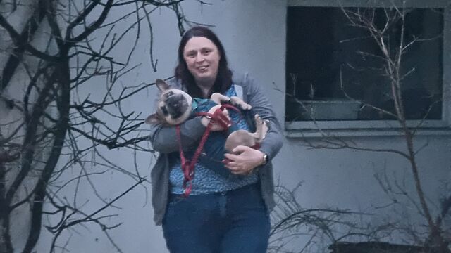 Close up of the woman carrying the dog.