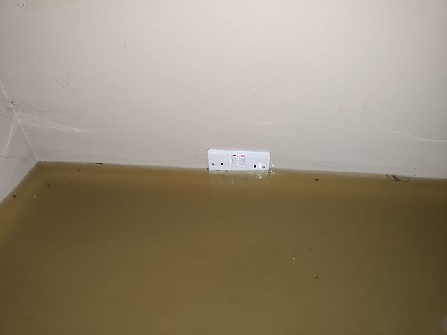 An electrical socket, partially underwater.