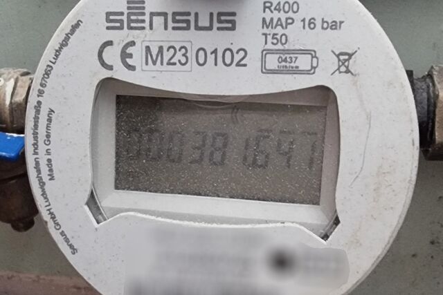 A digital water meter showing the value 381641.