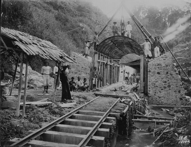  Workers pose at a railway tunnel under construction in the mountains.