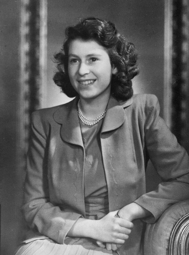 Princess Elizabeth sits comfortably in an upholstered chair.