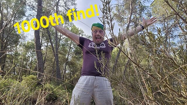 Dan with his arms raised in celebration, alongside the superimposed words '1000th find'.