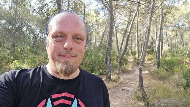 Dan, sweating, on a forest trail.