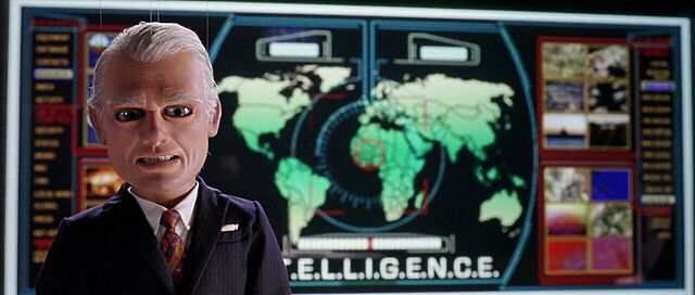 Scene from Team America: World Police, showing Spottswoode in front of INTELLIGENCE's computer screen, showing a world map.