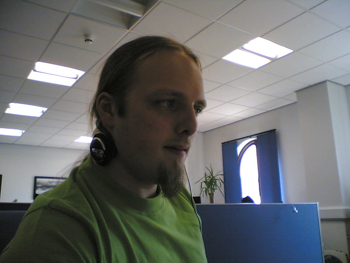Full image of Dan at work, listening to Pink Floyd and hammering out code