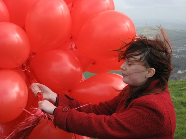 Full image of Claire is almost carried away by the balloons