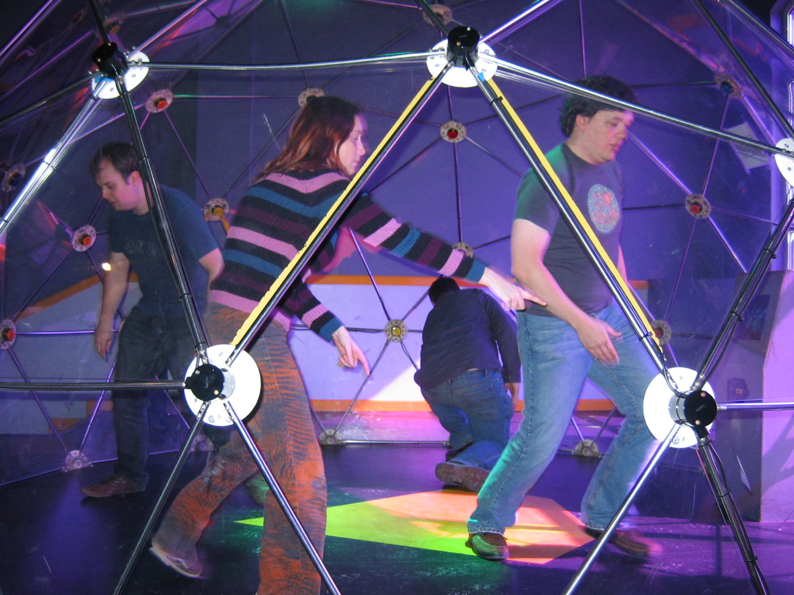 Full image of Claire points out a lit button to Gareth, in the dome