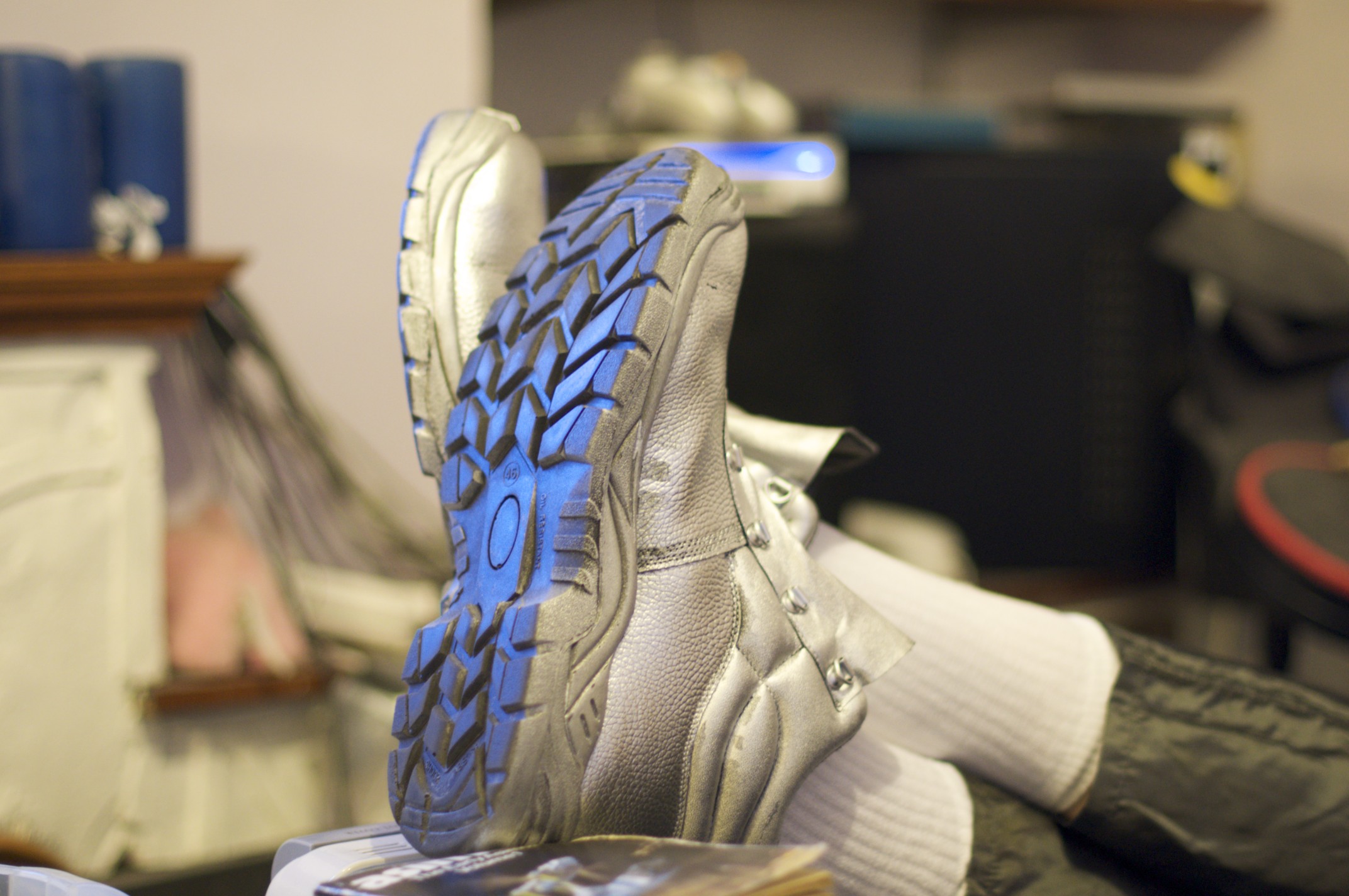 Full image of Adam's trainers, spray-painted silver.