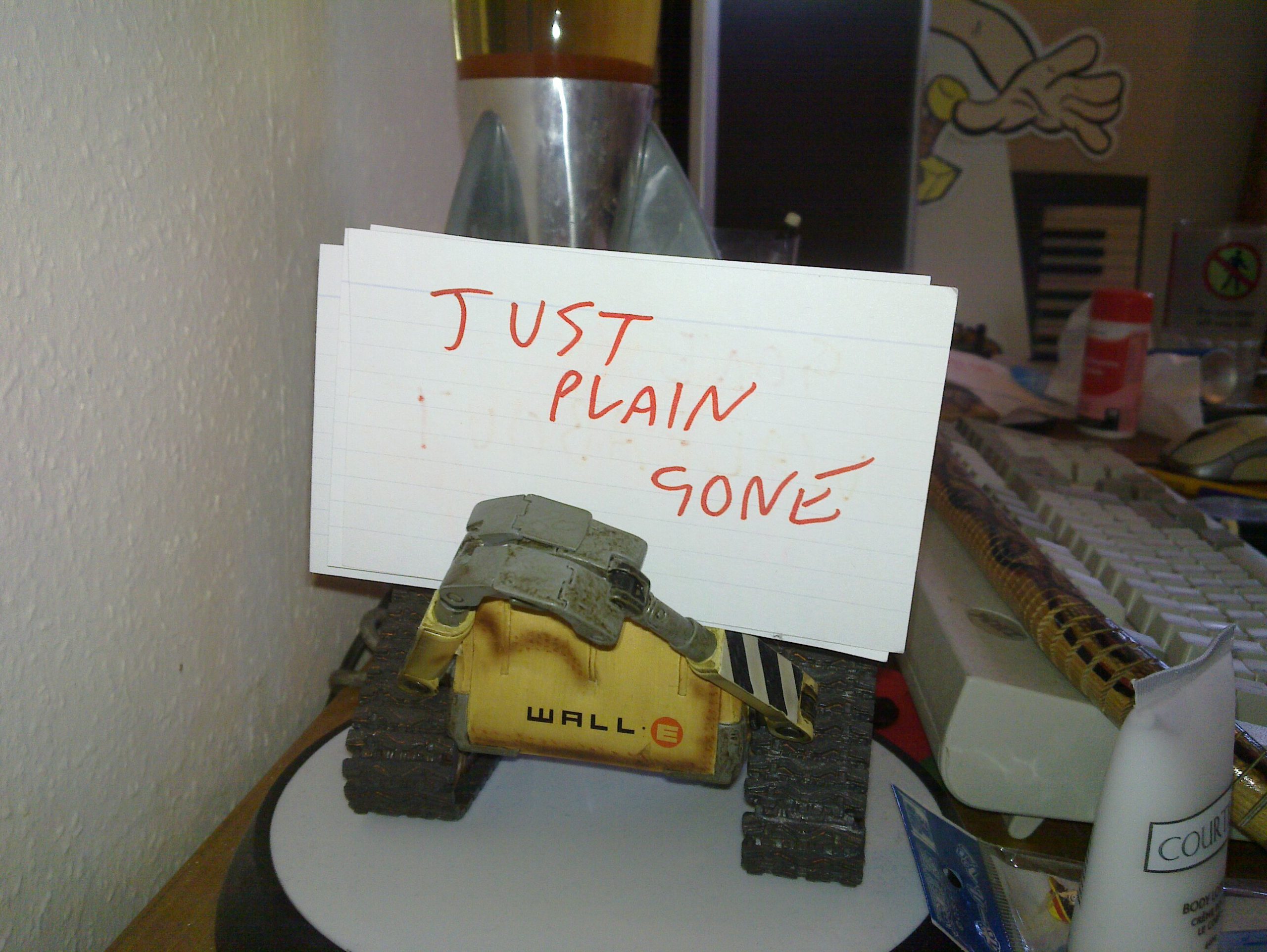 Full image of WALL-E holding a "just plain gone" sign.