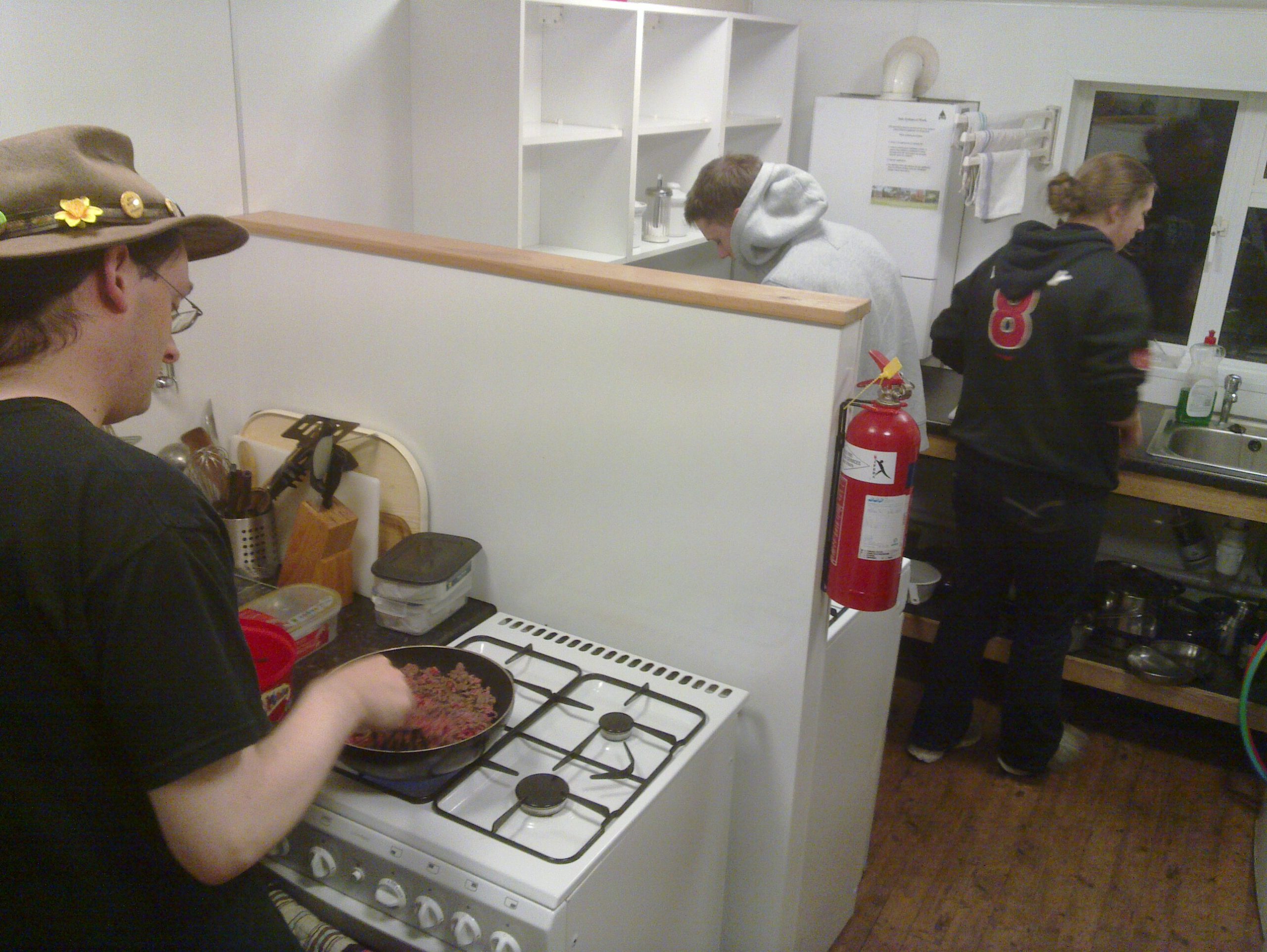 Full image of Paul, Robin, and Ruth prepare dinner.