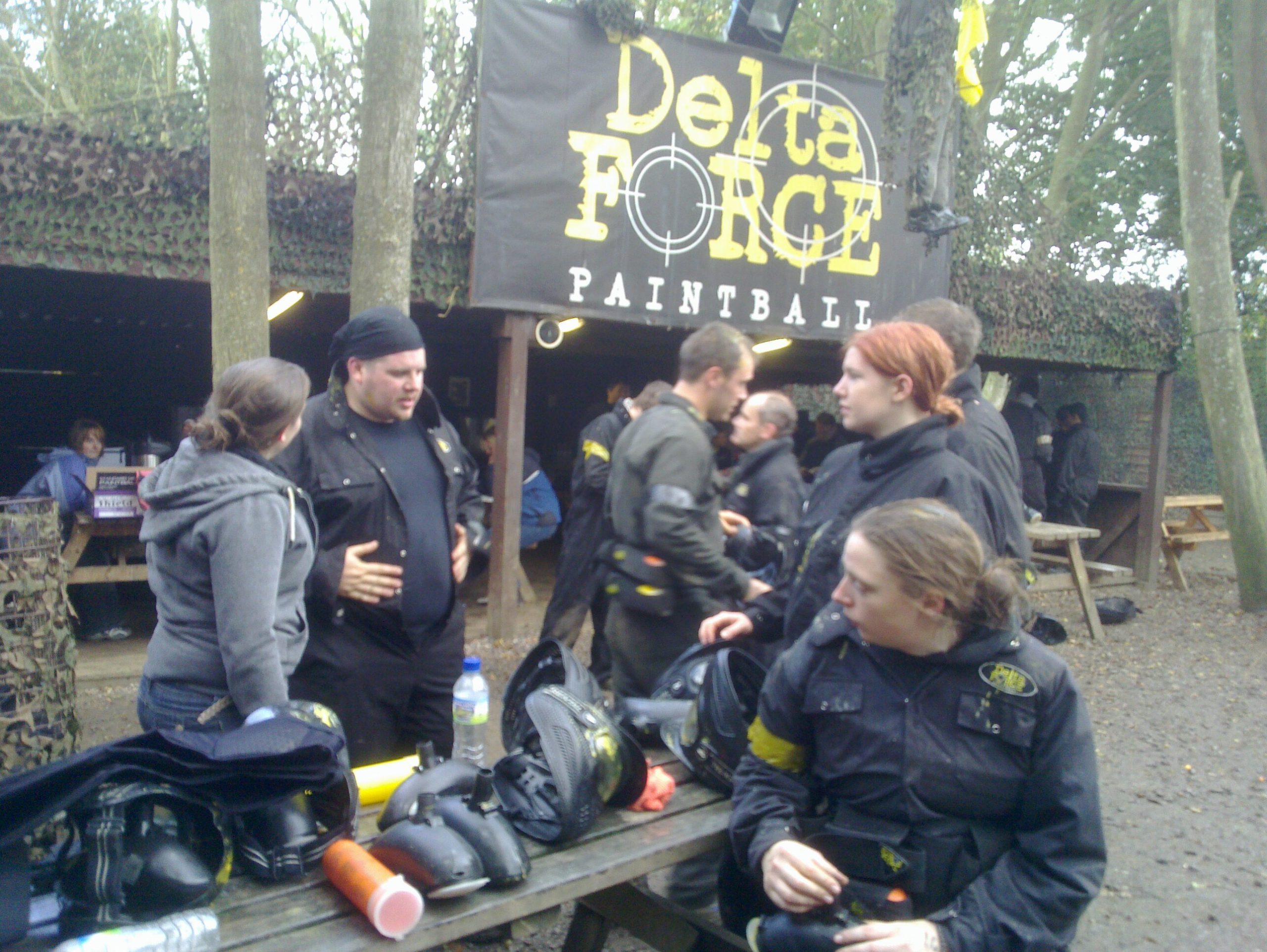 Full image of Party people planning paintball play preparations.