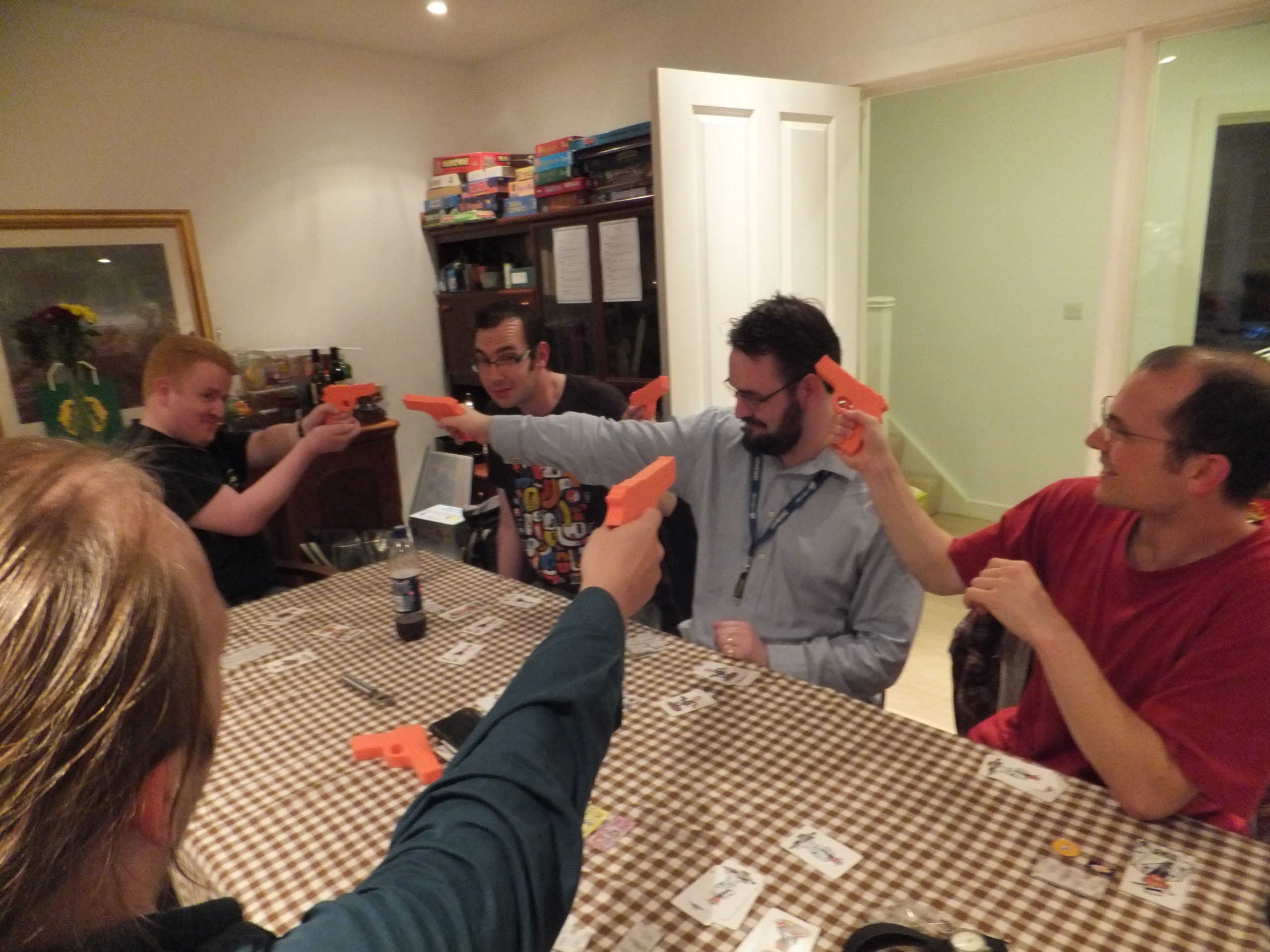 Full image of Some early guests play Ca$h 'N' Gun$, a live-action game of gun-toting gangsters.