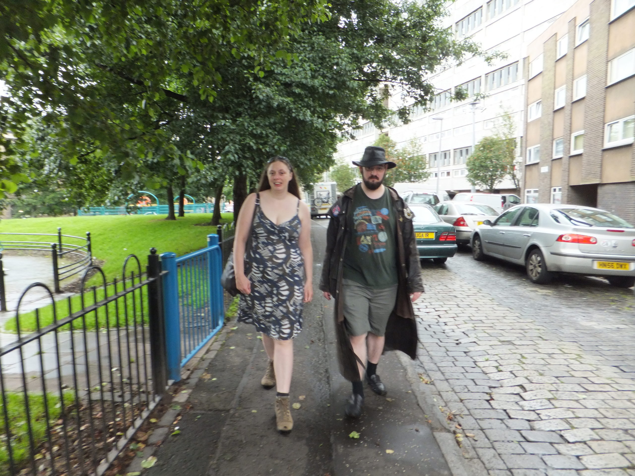 Full image of Ruth and JTA trudge through the wet suburban streets of Leith.