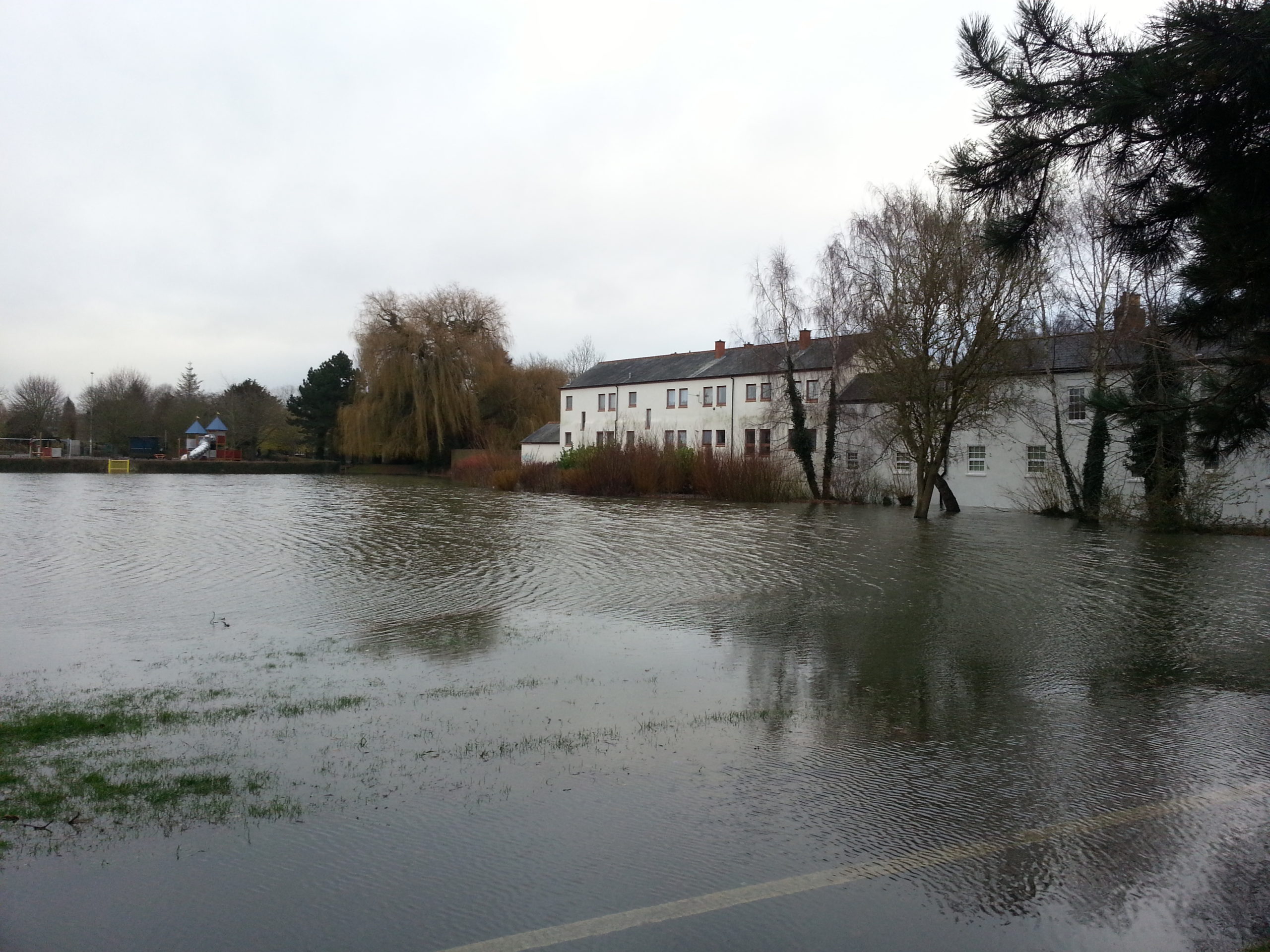 Full image of In Hinksey Park, the playing fields and cycle path are completely underwater.