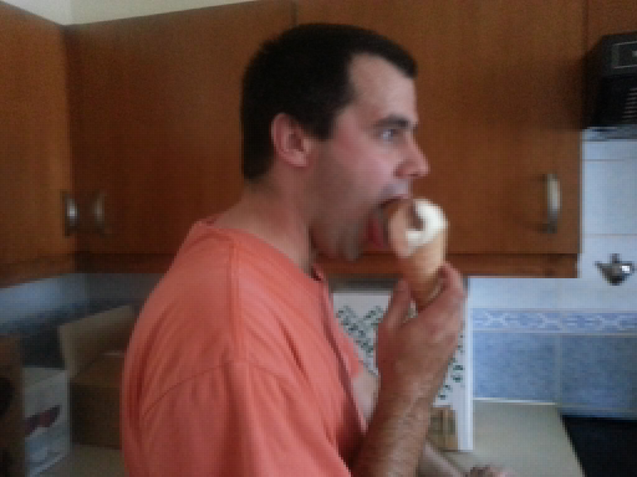 Full image of Matt filling his face with ice cream.