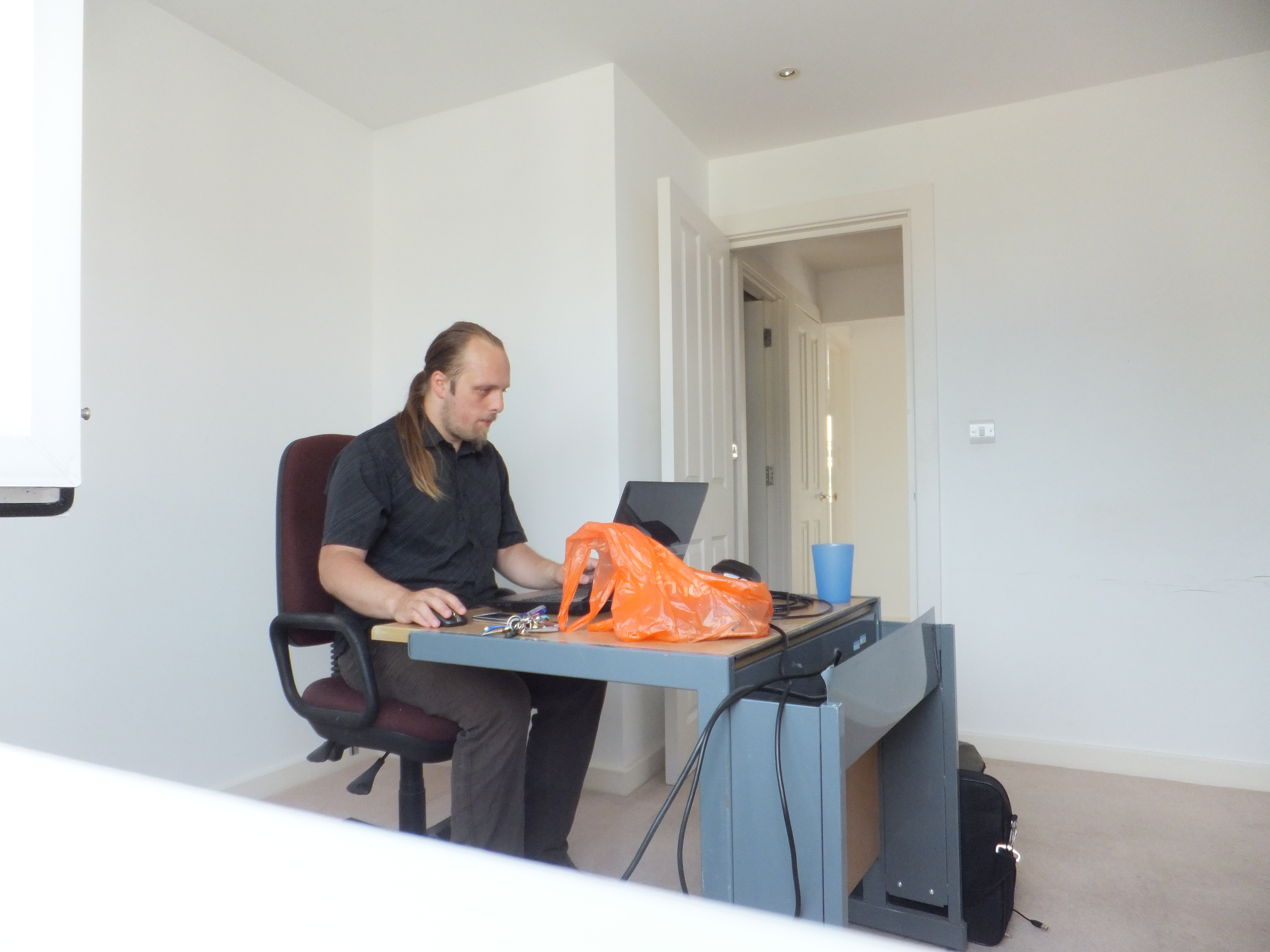 Full image of Dan works from home on the final day of the occupation of New Earth.